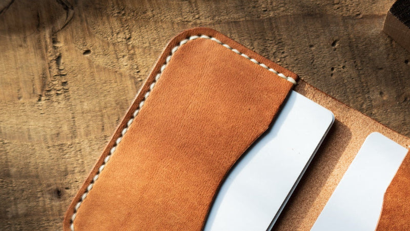 Close up of Maggie Bifold in Olmo Pueblo leather with white thread