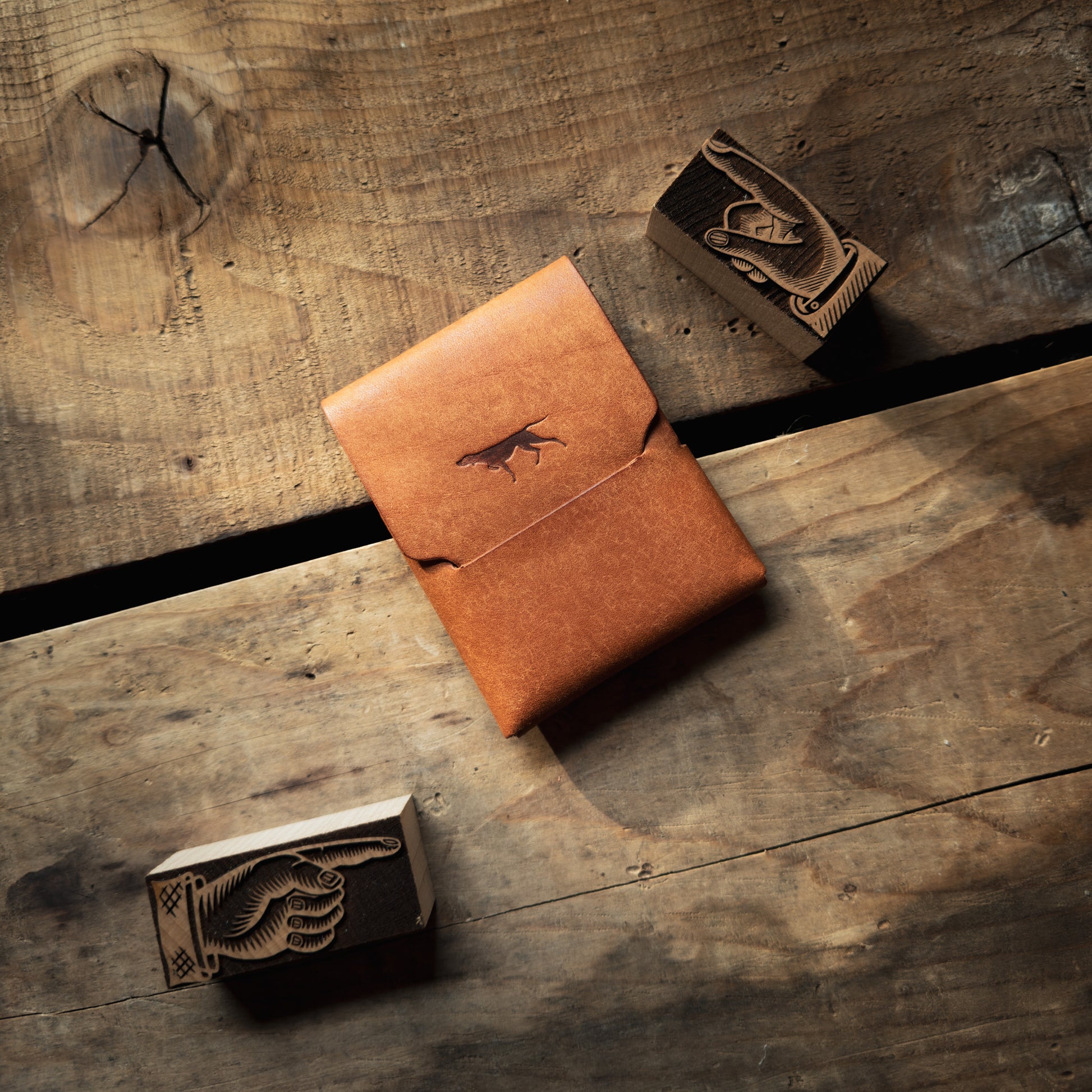 Stitchless Buck leather wallet by Hound Valley Goods in Olmo Pueblo leather on wooden background
