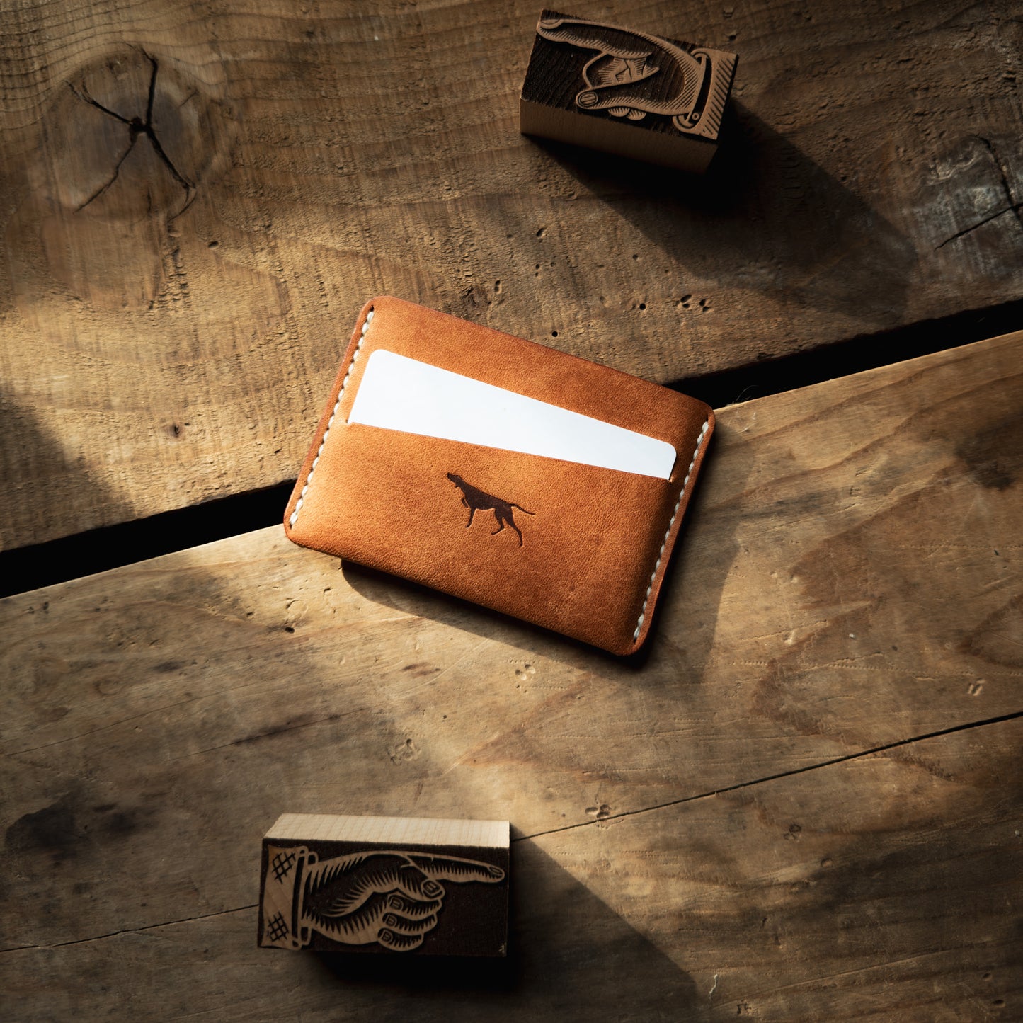 Sirius wallet from Hound Valley Goods in Olmo Pueblo with white thread on wood background